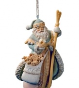 Adorned in traditional garb, Santa's Greatest Gift ornament sits upon your Christmas tree with Santa holding his magical snow globe and bag of treasures. Crystal embellishments add a touch of sparkle.
