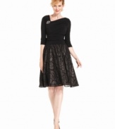 Luxurious touches make this petite SL Fashions dress a decadent choice for an evening occasion! You'll love the A-line fit, jeweled embellishment and velvety scroll through the skirt.