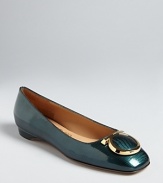 In high-polish leather with distinctive logo accents, these flats are fabulously Salvatore Ferragamo.