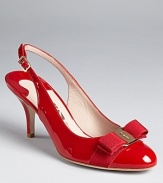 A logo ornament tops the grosgrain-wrapped toes of these chic, sleek patent heels. From Salvatore Ferragamo.