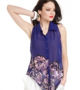 GUESS? goes bold in color and design, equipping a richly-hued blouse with floral print and a novel, asymmetrical hem!