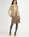 A soft, cozy style with multi-tonal leather trim. Wide dyed shearling collar with leather bucklesSleevelessFront zip closureTwo front leather patch pocketsLeather buckles at waistDyed lamb shearlingSpecialist dry cleanImported Fur origin: China Model shown is 5'10 (177cm) wearing US size Small.