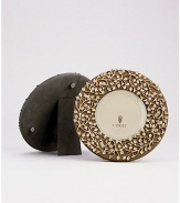 A charming, 14k goldplate floral motif is laid over a suede background, creating an eye-catching, completely handmade frame fit for any treasured photograph. From the Lorel Collection Accommodates a 4 diam. photograph Overall, 7 diam. Imported 