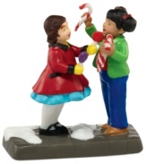 Two little girls exchange sweet gifts – traditional candy canes and lollipops bought fresh from Rachael's Candy Shop. A too-cute collectible from Department 56.
