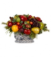 Top your table with a lively centerpiece. The Mixed Fruit planter features a myriad of fruits clustered with pine branches, showcasing one festive harvest.