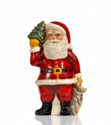 Handcrafted with traditional charm, this Santa Claus figurine wears his classic red suit and holds a bag of presents and a Christmas tree for an extra-festive feel. From Vaillancourt.