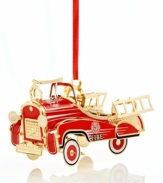 Steer this blazing red fire truck into your tree. Handcrafted in solid brass with gold rims and ladders, it's an authentic replica of the classic vehicle. From Baldwin.