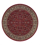 Inspired by the lovely Sarouk carpets of ancient Persia, this round rug features an intricate floral motif in ivory, sage green and accents of soft blue against a rich red ground.