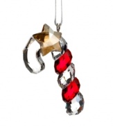 Shiny and sweet, the Swarovksi crystal candy cane ornament features ribbons of holiday red and a dangling gold star.