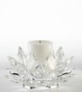 A fanciful crystal Lotus blossom from Lighting by Design brightens with the soft glow of candlelight for truly beautiful, over-the-top shine. Includes pillar candle.