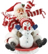 Going for a ride! With bright smiles and eyes filled with amazement, Santa and his pal display the excitement felt during the winter tradition of saucer riding.