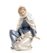 In her simple beauty, Mary peers down adoringly to where baby Jesus lays his head. Recreate the wonder, awe and miracle of Christmas with this delicately handcrafted nativity figurine from Nao by Lladro.