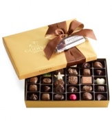 Enticingly wrapped with a satin brown and gold bow, this limited-edition collection of classic chocolates from Godiva is made even more delectable when topped with a complimentary dark chocolate soufflé dessert truffle bar!