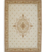 Evoking the opulence of European decor, this rug features an elegant medallion design in shades of gold on a cream background dotted with rosettes. Woven of premium wool for rich texture and indulgent softness.