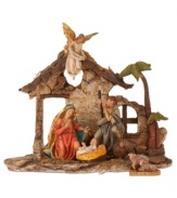 Mary and Joseph welcome baby Jesus into the world in this beautifully crafted nativity scene from Mark Roberts. An angel figure presides over them proclaiming, Gloria.