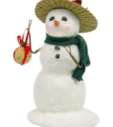With a bird nested in his hat and a ball of seeds for the taking, this generous snowman takes care of all the Christmas cardinals. Pristine snow glitters beneath a green scarf from Byers' Choice.