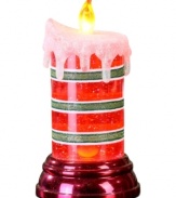 Set the mood. Give your house a festive glow this holiday season with the red and green striped LED candle from Napco. Glitter accents give it even more sparkle.