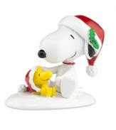 Snoopy and Woodstock play in the snow, enjoying all the magic and excitement of the holidays in this Peanuts Village figurine by Department 56.