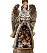 Heralding the birth of baby Jesus, this folk-inspired angel holds the iconic shining star and reveals the story of the nativity. Muted hues and delicate craftsmanship unveil the simplicity of Jesus' birth, as Mary, Joseph, the three kings and two gentle lambs draw near to the newborn babe.