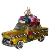 Trade in your sleigh for a classic New York City cab. Piled with presents and decked out with a wreath, this glass taxi ornament recalls the city's most magical time of year.