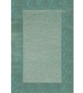 A looped center of mottled tones is framed by rich color in tufted pile, presenting a modern area rug that is both casual and practical. Hand tufted in India of pure wool fibers, the Madrid area rug is a comforting, stylish addition to any decor.