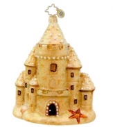 Holiday at the beach. Handcrafted in pure glass with glitter to create a grainy straight-from-the-shore feel, this sandcastle ornament from Christopher Radko gets you in the spirit in places without snow.