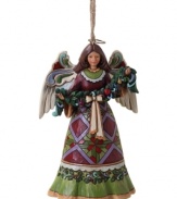 A peace offering for your tree, this beautiful angel ornament is draped with a lush garland of fruit and holly. Elaborate folk-art details in her skirt and rich colors throughout make it a Jim Shore classic.
