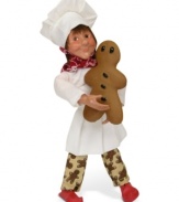 Big on sweets, this little Byers' Choice baker puts the finishing touches on a traditional gingerbread man. He's dressed the part too, wearing cookie-patterned pants with traditional chef's whites.