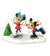 Mickey and Minnie make the most of a winter wonderland, ice skating happily together on a frozen pond in Mickey's Village. From Department 56.