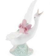With her beak to the sky and a bouquet of orchids in tow, this graceful duck is on the move in magnificent Lladro porcelain.