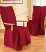 Dense cotton duck instantly transforms any furniture with its broad arm construction and an elegant draping at the bottom. This slipcover also features front pleats for a beautiful all-around drape that accommodates dining room chairs with flared legs.