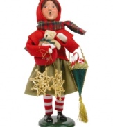 A young girl helps with the holiday shopping, picking up traditional straw ornaments, a teddy bear and treats in this handcrafted figurine from Byers' Choice.