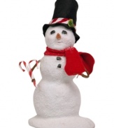 Sweetening the holiday season, this young snowman carries two candy canes to complement his hat. A red scarf completes his outfit from Byers' Choice.