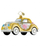 Make a quick holiday (or honeymoon) getaway with a golden chariot from Christopher Radko. Glittering hearts detail a vintage car, dated 2012.