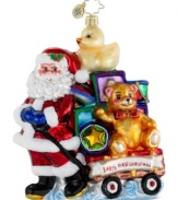 Pull out all the stops for your baby's first Christmas with an ornament handcrafted by Christopher Radko. Santa delivers a wagon stacked with toys in bright, shiny colors to commemorate the happy occasion.