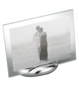 Keep memories fresh in the modern Elbow picture frame. A sculpted metal base turns back in an elegant curve, fitted with sheets of clear glass for displaying any photo, vertical or horizontal. Designed by Neil Cohen for Nambe.