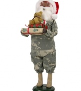 Singing their praises, Santa Claus honors military families in a camouflage suit and iconic red hat. In his arms are extra-special gifts piled high and topped with an adorable stuffed bear. An all-American figurine, handcrafted by Byers' Choice.