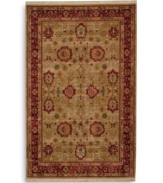 Inspired by an early 20th-century carpet woven in western Turkey, this oushak rug features an enlarged palmette trellis design surrounded by a rosette border in a rich palette of red, gold and green. Subtle gradations of color evoke the timeworn striated effect created by aged vegetable dyes. A patented wash process further harmonizes the colors into a rich vintage finish. Woven in the USA in premium worsted New Zealand wool for luxurious softness.