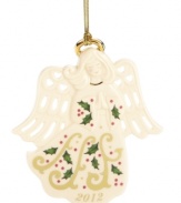 Serene and beautiful, the Joyous Tidings Angel ornament from Lenox is crafted of glazed ivory porcelain with a golden halo, Christmas greenery and pierced hearts in her wings.