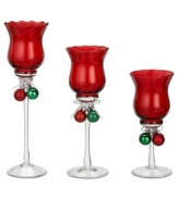 In opulent red glass, these votive holders from Ganz give a festive glow to your home this holiday season. Each holder features a duo of classic Christmas ball ornaments tied with ribbon around the stem.