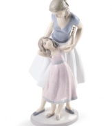 Like mother, like daughter. A lovely duo in beautifully painted porcelain, this Lladro figurine is a heartwarming memento for any family.