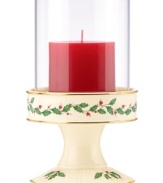 With bands of gold and a holly motif to match the beloved Holiday dinnerware pattern, this porcelain candle holder from Lenox creates instant Christmas ambiance. With red candle and glass shade.