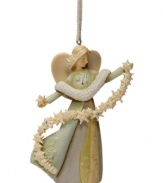 Let it snow. This lovely angel holds a shimmering strand of extraordinary snowflakes in this Angel with Snowflake ornament. Finished with sparkling crystal accents.