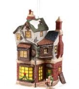 Home is where the heart is. This brilliantly crafted porcelain ornament from Department 56 displays Bob Cratchet's house as a special delivery is being made for the family on Christmas day. Intricately painted to mirror Dickens' beautiful settings in A Christmas Carol.
