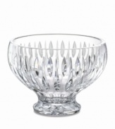 A series of vertical wedge cuts around the side of this lead crystal bowl create an effect of subtle radiance. Measuring 8 in diameter with a dramatic raised base.