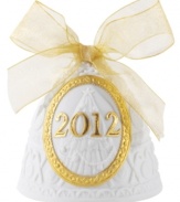 Jingle all the way. Featuring sculpted white porcelain tied up in a shimmering gold bow, this handcrafted bell ornament by Lladro makes your Christmas tree sing year after year.
