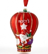 Santa and friends wave hello-ho-ho from the macy's hot air balloon. In gleaming red with gold glitter and Christmas garland, this whimsical ornament takes your tree to festive new heights.