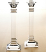 A modern take on a classic design, these crystal candlesticks feature sleek lines and sharp, precise edges that converge on a substantial base. In clear lead crystal.
