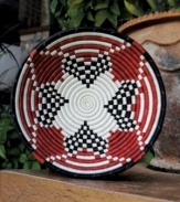 Rwandan women pour heart and soul into the Urukundo fruit bowl, a basket made with and symbolic of love. Hanging on a wall or topping a coffee table, the hand-woven red, black and white pattern makes a bold, meaningful statement.