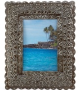 From steel barrels to artful display, this eco-friendly picture frame is painstakingly cut and carved by esteemed Haitian artisans. A scalloped design evokes the scales of a mermaid's tail, bringing a touch of fantasy to any landscape.